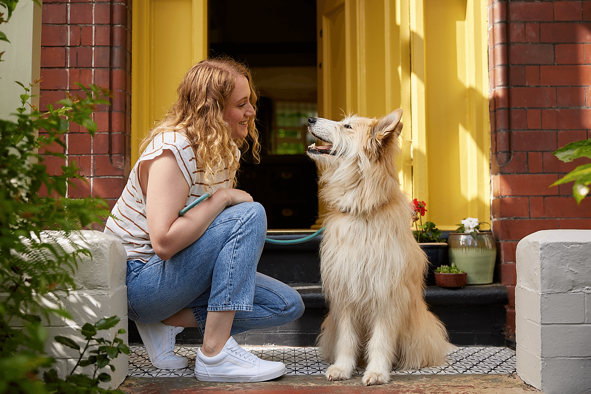 A lady interacting with her dog